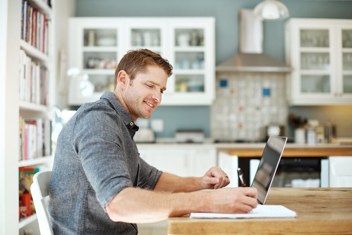 man studying using laptop at home