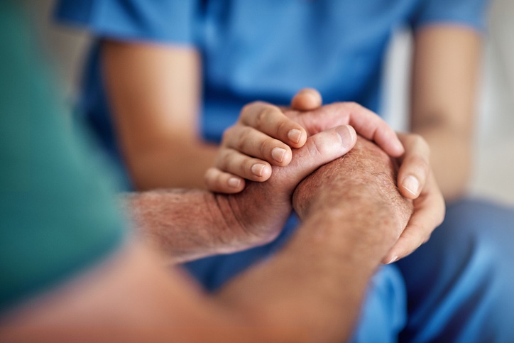 Healthcare provider holding patient's hands