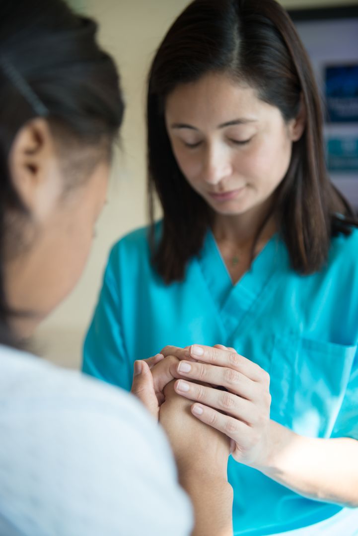nurse praying with patient