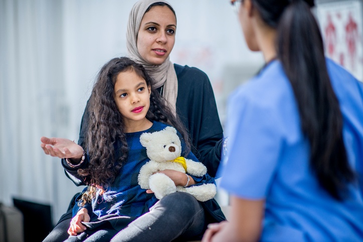 nurse talking with muslim mother and daughter in the emergency department